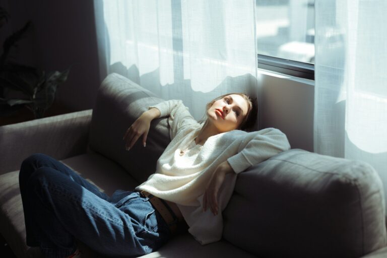 Frau ruht auf einem Sofa – Alltag, Rhythmus, Erholung und hormoneller Kontext